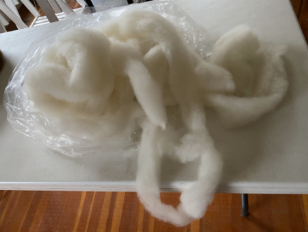 finished  loose roving spilling out of a clear plastic bag