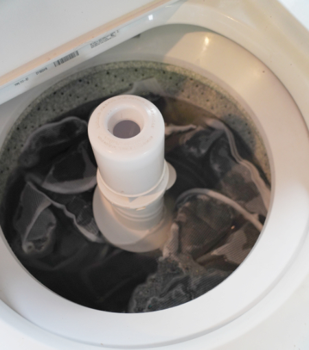 looking into a washing machine at fiber being scoured